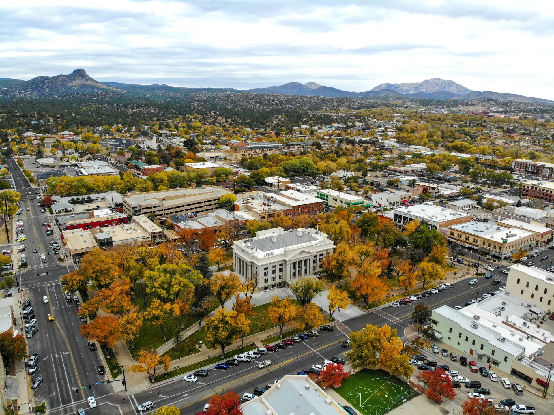 Aerial view of historic downtown Prescott, Arizona with Courthouse Plaza, fall colors, and surrounding mountains