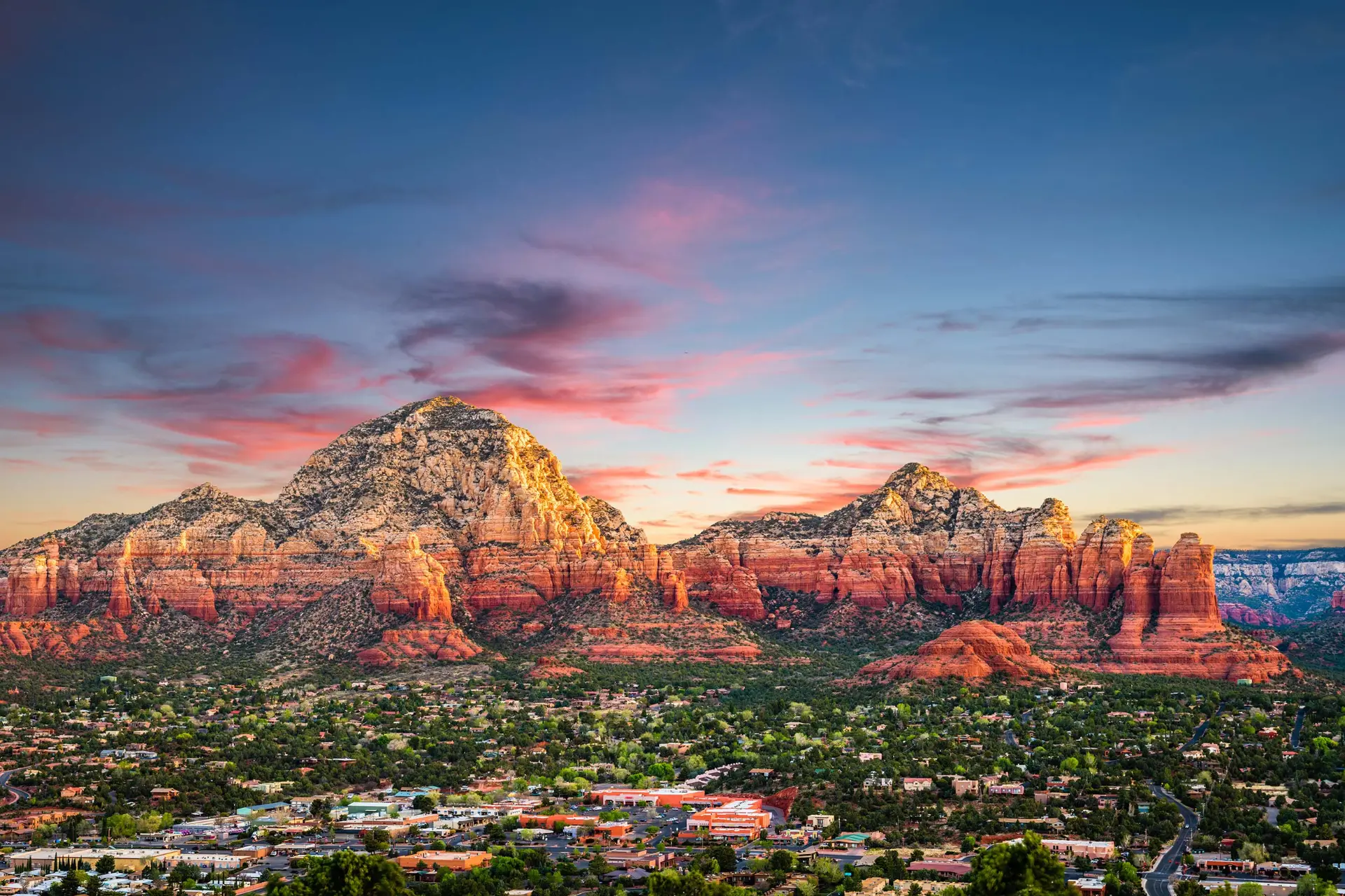 Sunset panorama of Sedona, Arizona red rock formations with the town below